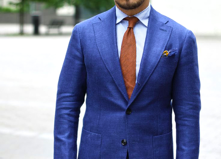 Complementary colors scheme: Navy suit dark orange tie color combination.