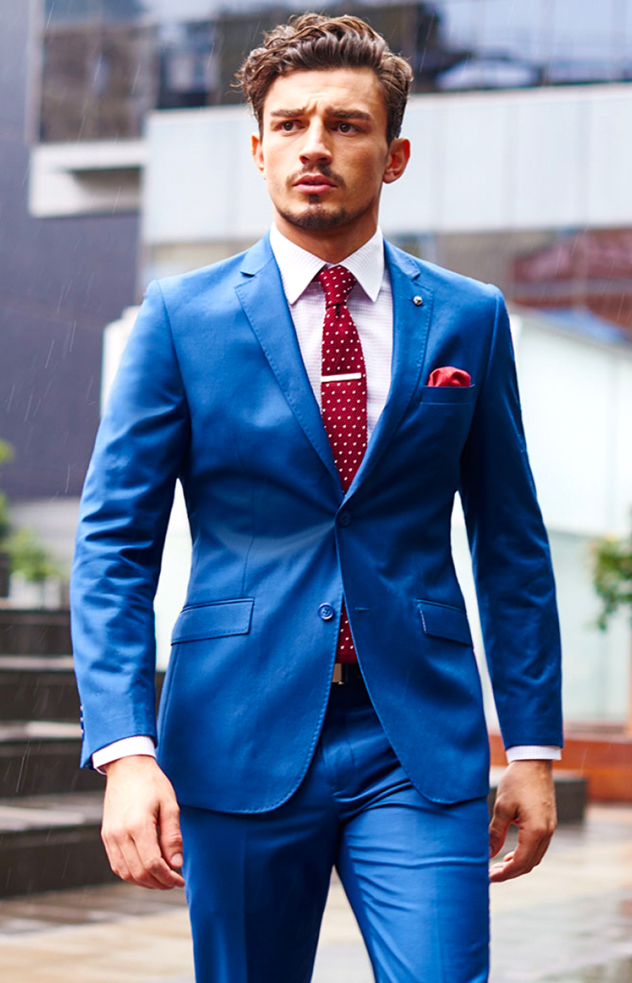 Blue suit matched with a red tie