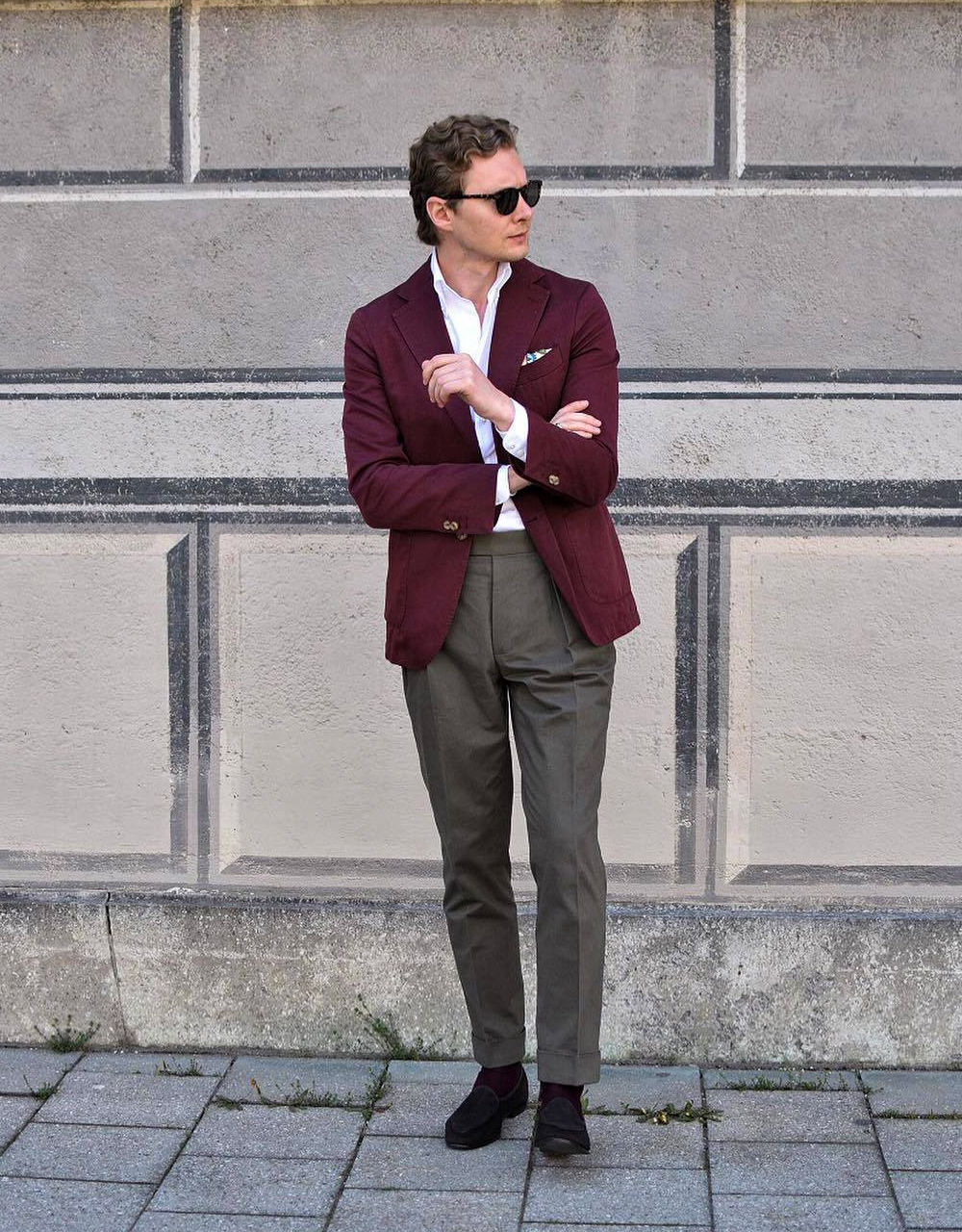 Fashionable Man Posing In Beige Pants And Burgundy Sweater With Autumn  Jacket On Shoulder On Grey Stock Photo - Download Image Now - iStock