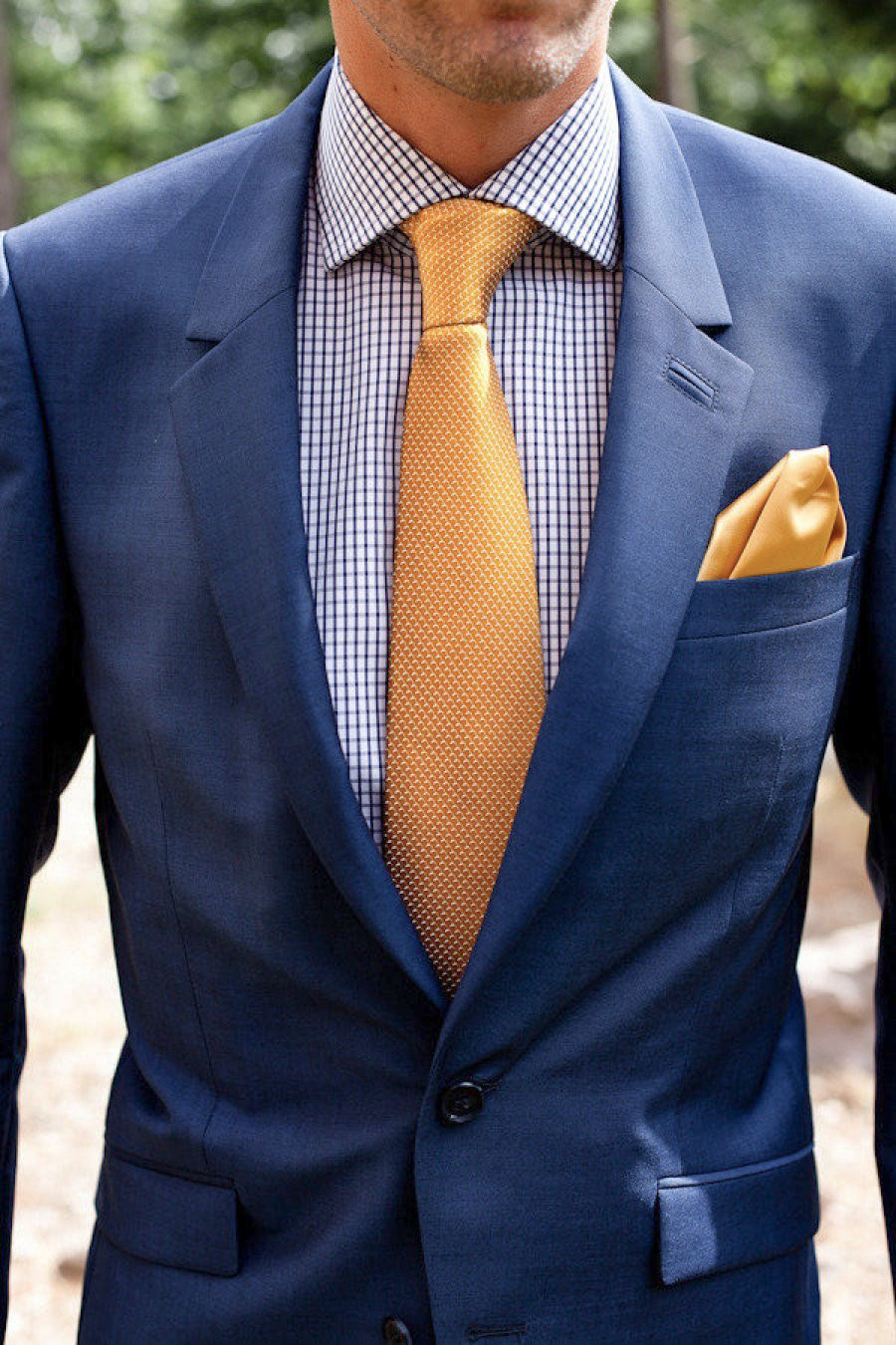 navy suit and checkered shirt